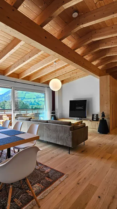 Sandro Anibas sitzt in einer luxuriösen Wohnung und schaut lächelnt von einer Zeitschrift auf