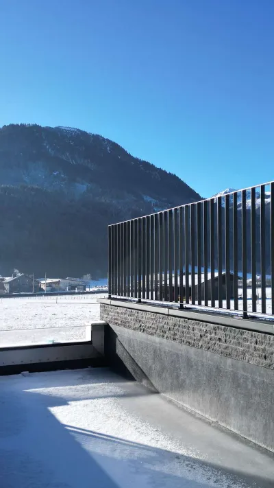 Sandro Anibas sitzt in einer luxuriösen Wohnung und schaut lächelnt von einer Zeitschrift auf