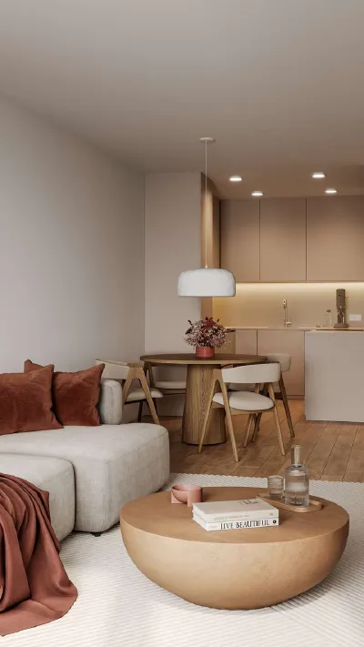 Sandro Anibas sitzt in einer luxuriösen Wohnung und schaut lächelnt von einer Zeitschrift auf