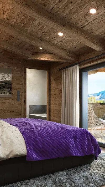 Sandro Anibas sitzt in einer luxuriösen Wohnung und schaut lächelnt von einer Zeitschrift auf